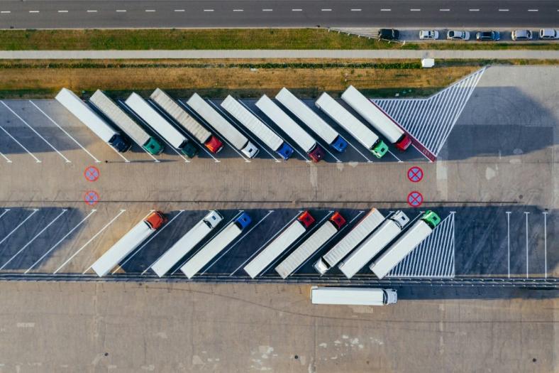 Aerial view of freight trucks and trailers at a logistics facility