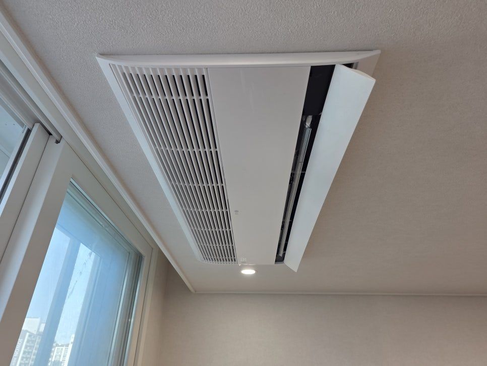 Owned reference photograph showing a ceiling-mounted indoor air conditioning unit and the surrounding ceiling.