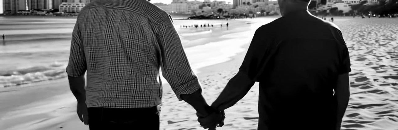 Two old men holding hands by the sea: "Envejecer" by Mike Sain't Louis mourns the future that was promised