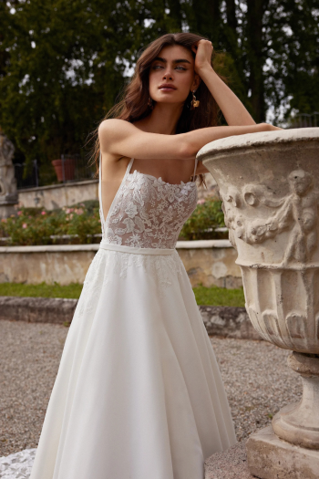 Bride wearing a floral lace bodice A-line wedding dress with spaghetti straps and flowing tulle skirt at Flares Bridal, serving San Francisco and Bay Area brides
