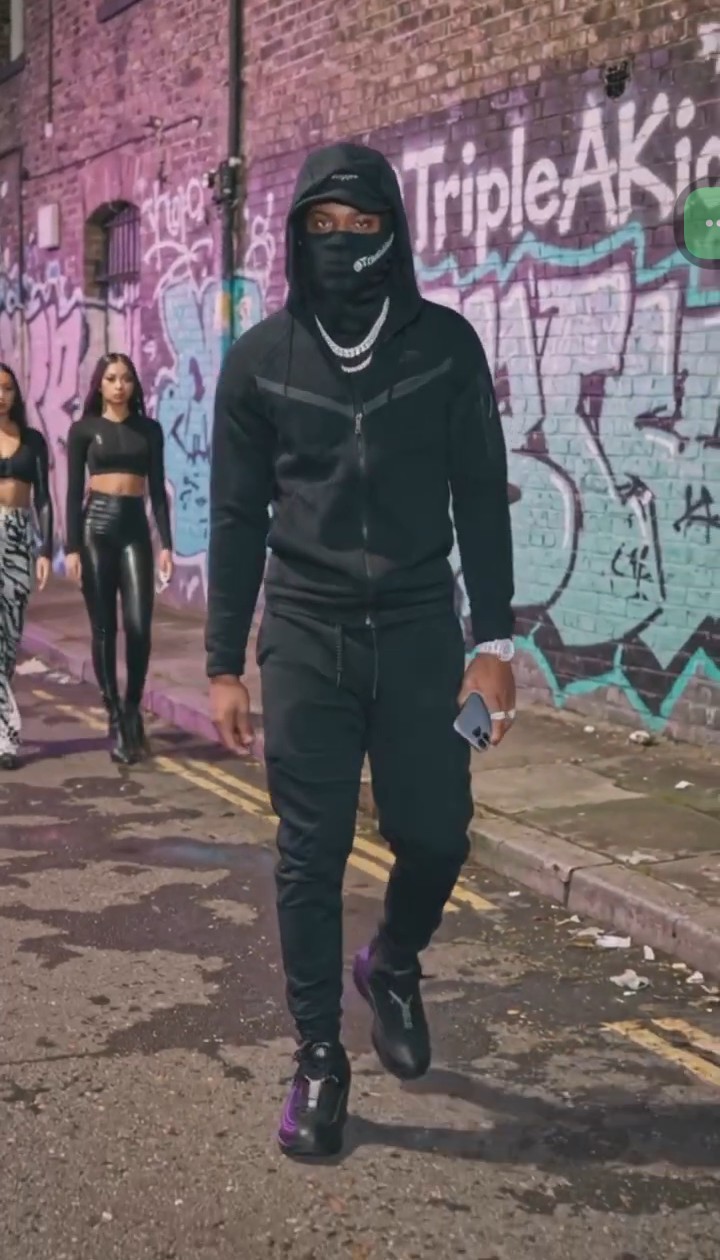 Singer, Songwriter, Triple A Kidd (Front) seen walking on a block